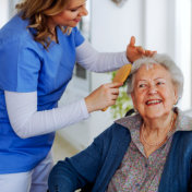 caregiver woman combing a senior woman's hair