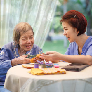 Elderly woman with caregiver