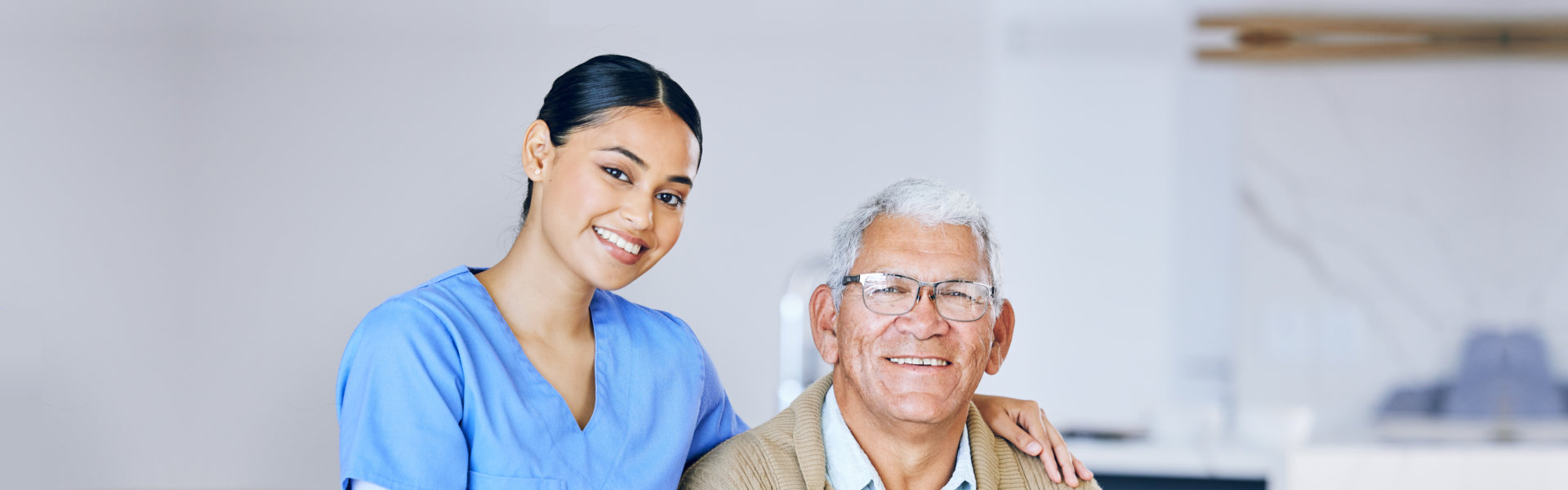 caregiver with senior patient smiling